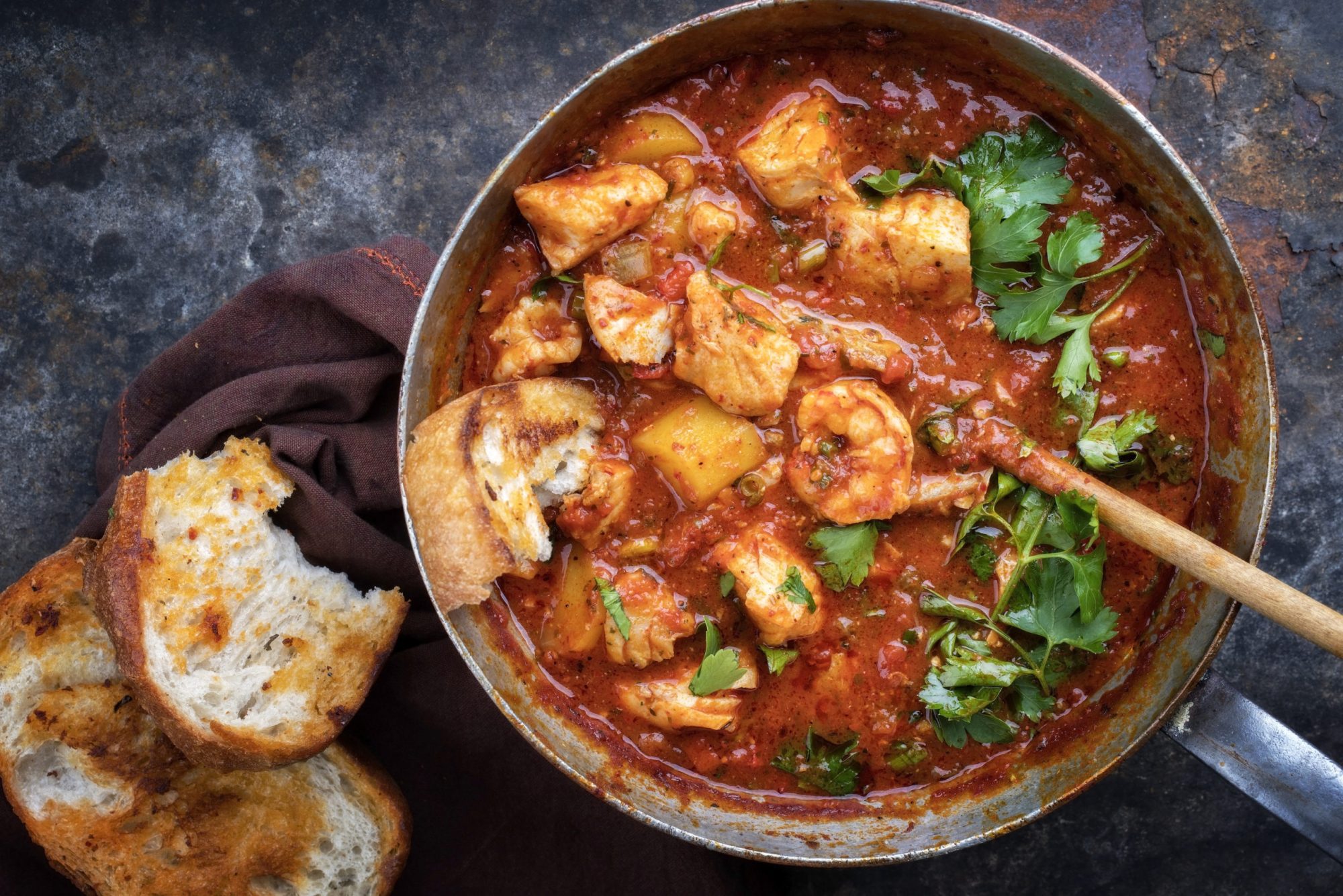 Traditional Creole cajun court bouillon with fish and seafood gumbo chowder stew as top view in a pot Traditional Creole cajun court bouillon with fish and seafood gumbo chowder stew as top view in a pot