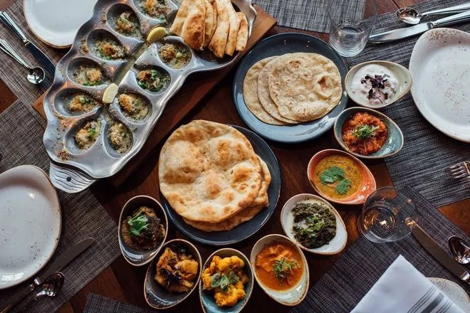 a bunch of food sitting on top of a wooden table